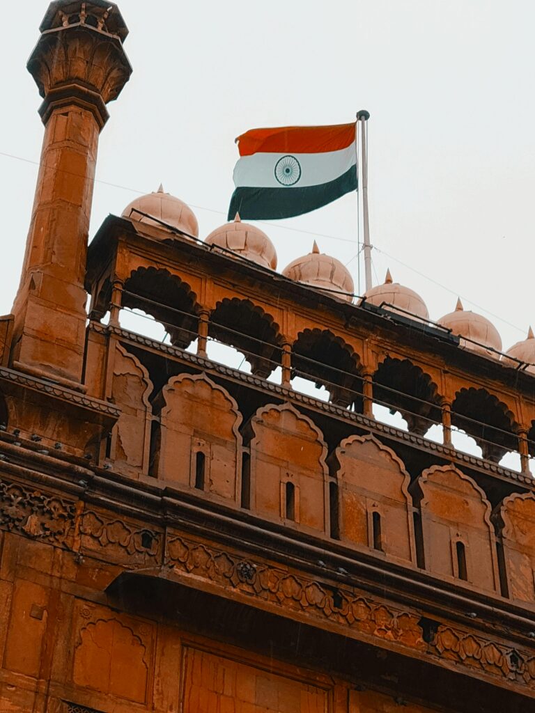 Historic Red Fort with Indian flag in Delhi, India, symbolizing independence.