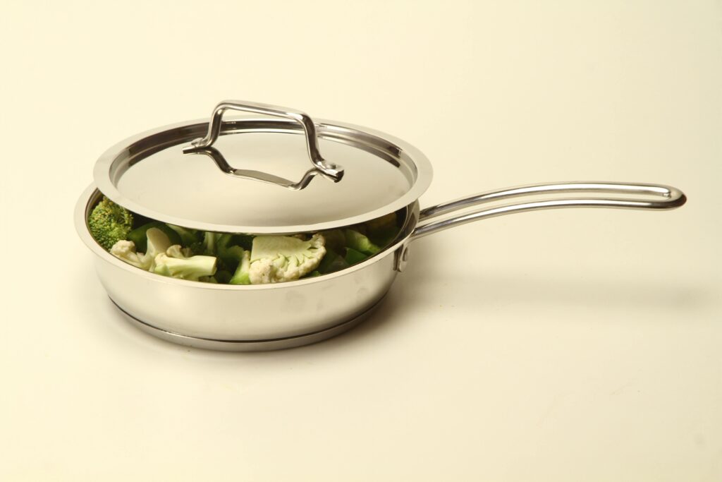 Modern stainless steel pan with vegetables, ideal for healthy cooking.
