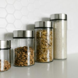 Stylish glass jars filled with food for a modern kitchen organization.